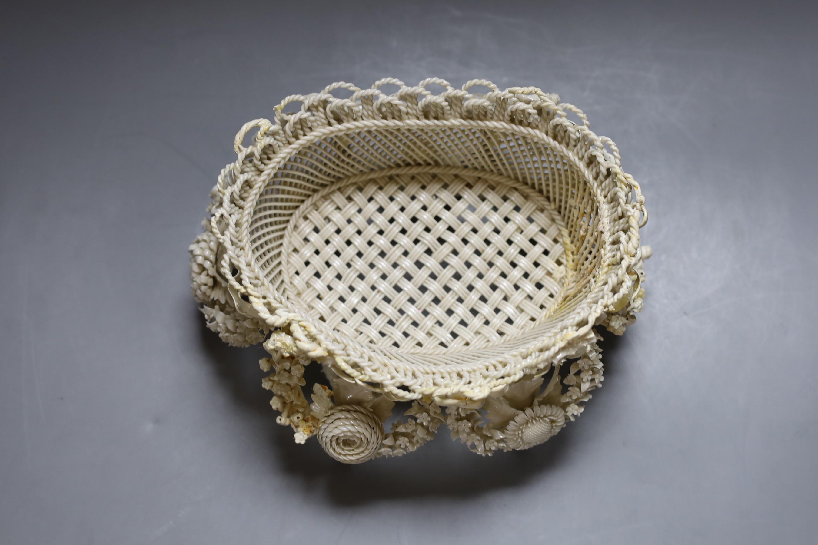 A Belleek floral encrusted basket (restored), 24cm
